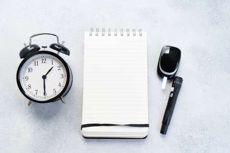 Diabetes diet planning concept, set of watch, notepad and glukometrの写真素材