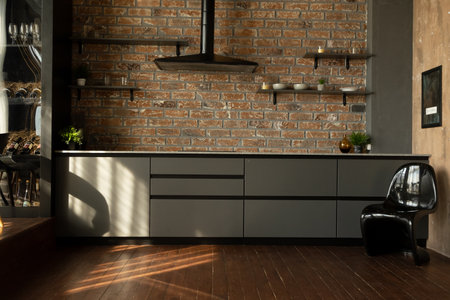 dark stylish kitchen with hood and shelvesの写真素材