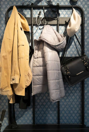 white modern wardrobe withfemale red and blue closingの写真素材