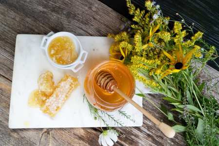 fresh honey in jar with honeycombs on rustic background, top viewの写真素材