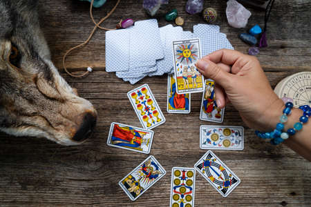 Fortune telling on tarot cards, witch hand is opening cards, used Marseille Tarot deck by unknown...