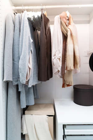 white modern wardrobe withfemale red and blue closingの写真素材