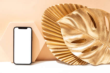 Golden leaves styled stock scene, stylish mock up with copy space on modern phone display, social media mock upの写真素材