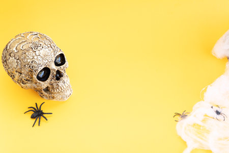 Dia de los muertos traditional holiday - day of the dead - skull in flowers, traditional symbol over yellow background, frame with copy spaceの写真素材