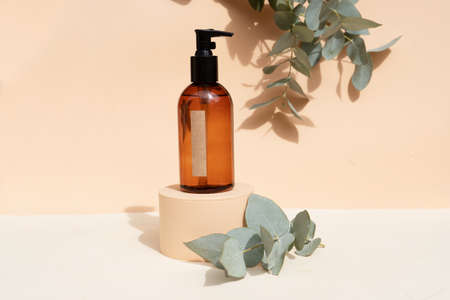 Minimal modern cosmetic products display with one bottle on neutral beige background with shadow overlayの写真素材