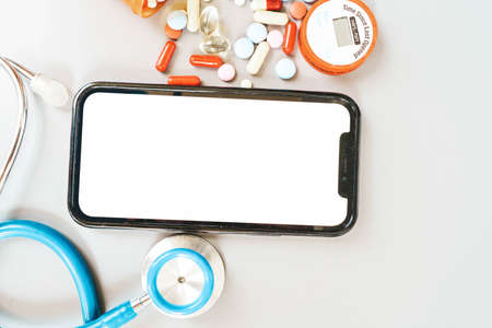 online telemedicine concept, stethoscope and pc keyboard with modern phone, medical app mock upの写真素材