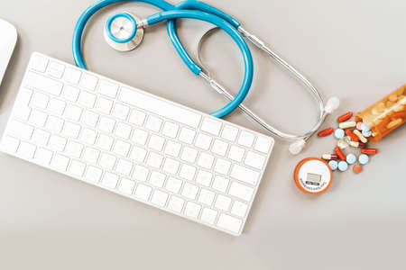 online telemedicine concept, stethoscope and pills with pc keyboardの写真素材