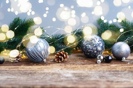Elegant gray christmas scene on natural wood table background with bokeh lights in backgroundの写真素材