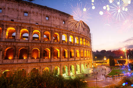 view of Colosseum illuminated at night with fireworks in Rome, Italyの写真素材