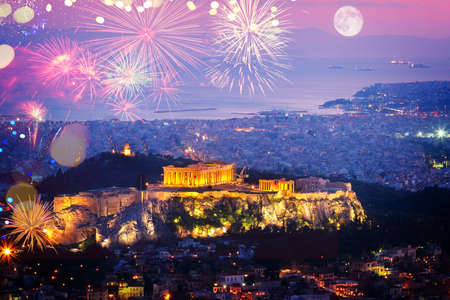 cityscape of Athens with illuminated Acropolis hill and see with fireworks, Pathenon and sea at night, Greeceの写真素材