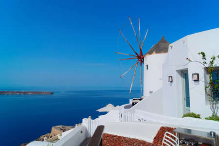 Oia, traditional view with white windmill, white greek village of Santorini, Greece
