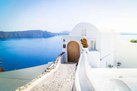 beautiful details of Santorini island - typical house with white walls and blue waters of Aegan sea, Greeceの写真素材
