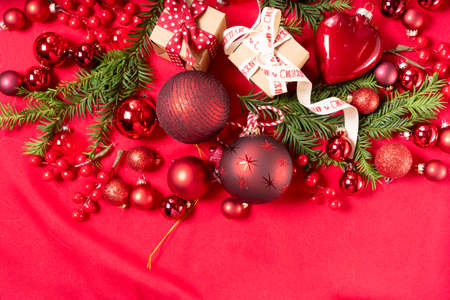 Monochrome red christmas lifestyle - holiday decorations and gift boxes top view border
