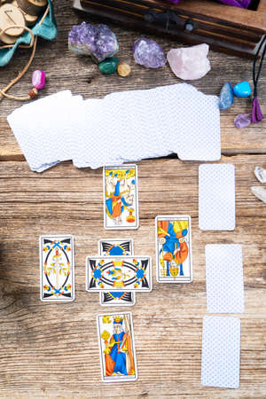 Fortune telling on tarot cards, deck are placed in cross figure, top view, used Marseille Tarot deck by unknown artist published first in 1709の写真素材