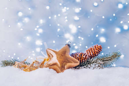 White christmas with snow - golden star and evergreen fir tree decorations with magic festive lightsの写真素材