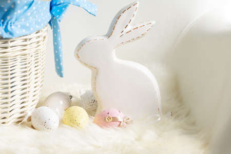 Easter Egg hunt with Easter white bunny over white chair backgroundの写真素材