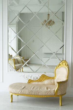 Stylish living room interior of classic apartment and trendy furniture, big mirror and elegant...