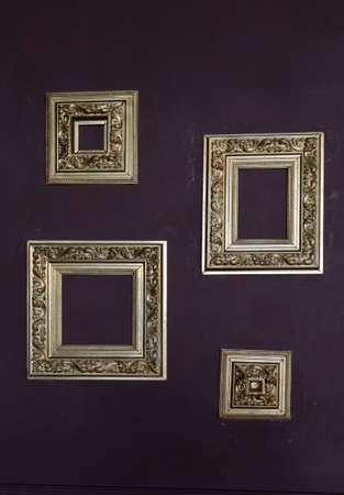 Set of vintage golden frames on dark wall