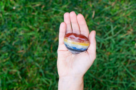 Hand holding set of chakra stones in heart shape. Magic healing Rock for Reiki Crystal Ritual, Witchcraft, spiritual esoteric practiceの写真素材