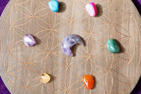 Gemstones minerals chakra stones over life flower chart. Magic healing Rock for Reiki Crystal Ritual, Witchcraft, spiritual esoteric practiceの写真素材
