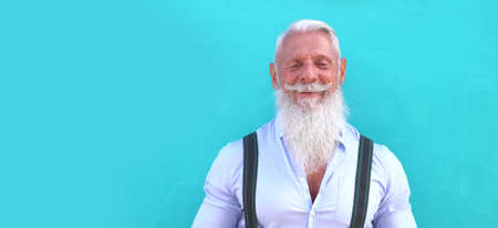 Happy senior man outdoor communicating via video call, looking at the camera and smiling, new normal...