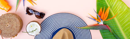 Summer flat lay top view frame with beach accessories frame on pink background with copy spaceの写真素材