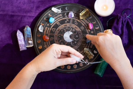 Top view of astrologer hands making forecast of fate. Astrological forecast, mysticismm and science concept. Astrological background.の写真素材