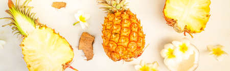 Summer flat lay scene with tropical fruits pineapples and coconuts on gray wooden , tonedの写真素材