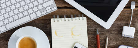 Top view of workplace - empty notebook with gudgets