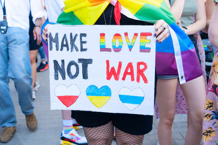 Gay pride parade, someone with make love not war posterの写真素材