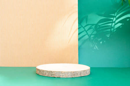Minimal modern product display podium on reach green and textured brown background with wooden podium and shadow overlayの写真素材