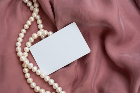 Pearl jewellery and silk styled stock scene, for wedding invitation, product showcase or styled presentation with copy space, top viewの写真素材