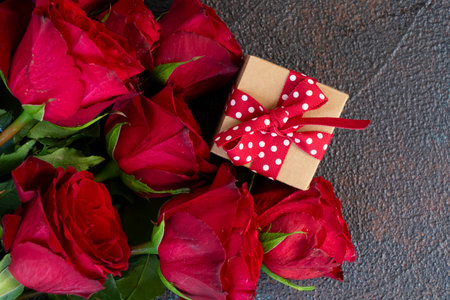 Crimson red rose flowers bouquet with gift box, Valentines Day background