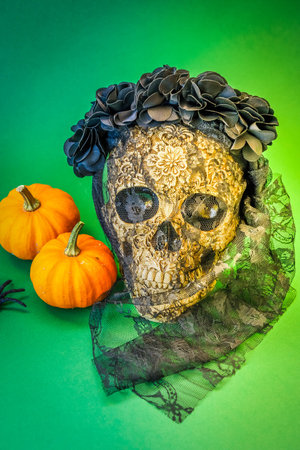 Dia de los muertos traditional holiday - day of the dead - skull in veil in flowers on green...