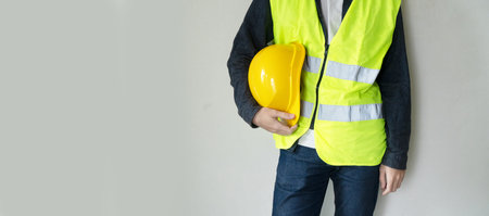 ingineer on construction site, architector with helmet, copy space on wallの写真素材