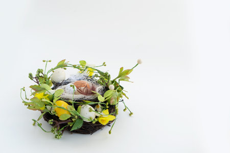 Easter scene with colored eggs in nest with tulips and bunnyの写真素材