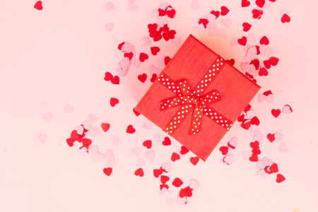 Valentines day festive background with pink hearts and red gift boxの写真素材