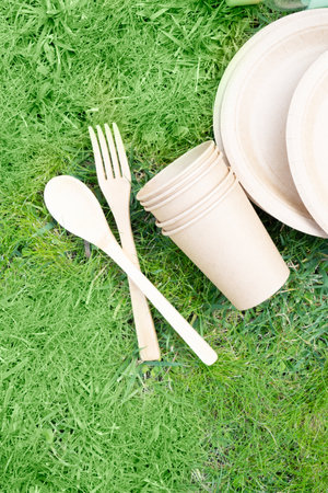 Zero waste concept, disposable tableware over green grassの写真素材