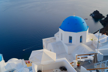 traditional greek village Oia of Santorini, with blue domes of churches and village roofs, Greeceの写真素材