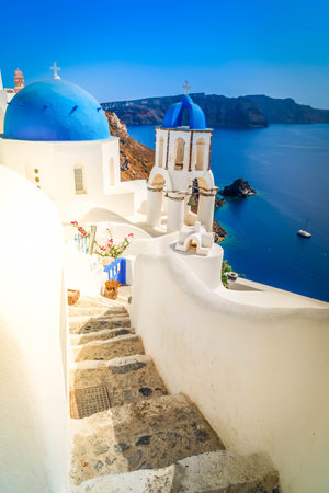 traditional greek stairs in village Oia of Santorini, with stairs and blue dome, Greeceの写真素材