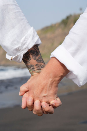 lifestyle with caucasian senior couple resting on beach, holding hands close up, happy in love romantic and relax time, tourism of elderly family pleople, leisure and activity travel after retirementの写真素材
