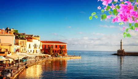 famouse venetian harbour waterfront and lighthouse of Chania old town, Crete, Greece with flowersの写真素材