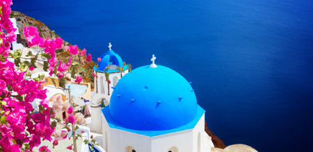view of caldera with blue church domes, Oia with flowers, Santorinirの写真素材