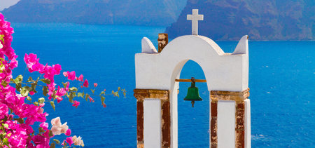 white church belfry and volcano caldera, beautiful details of Santorini island, Greece with flowersの写真素材