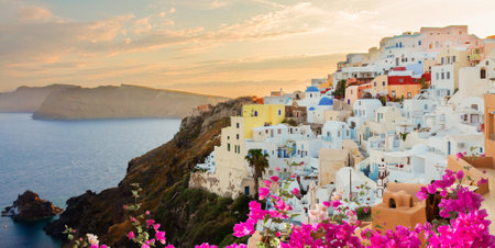 townscape of Oia with flowers, volcano caldera and Aegan sea, beautiful details of Santorini island at sunset, Greeceの写真素材
