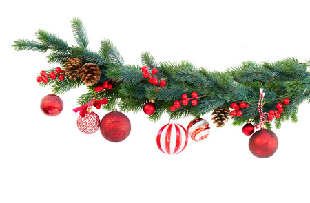 Decorated with red balls green christmas tree close up on white backgroundの写真素材