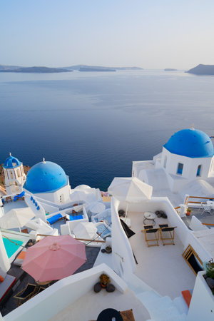 traditional greek village Oia of Santorini, with blue domes of churches and village street, Greeceの写真素材