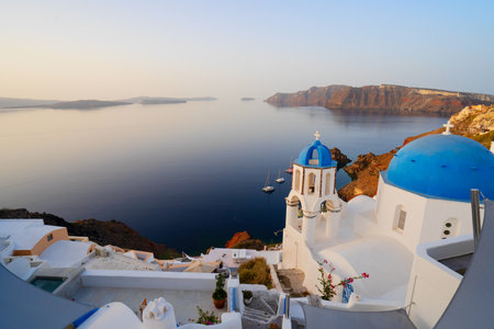 street of traditional greek village Oia of Santorini, with blue domes against Aegan sea and caldera, Greece, web banner formatの写真素材