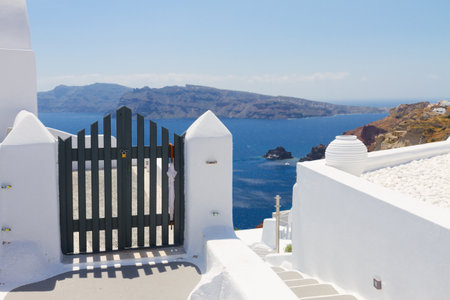 blue gates against volcano caldera and Aegan sea, beautiful details of Santorini island, Greeceの写真素材