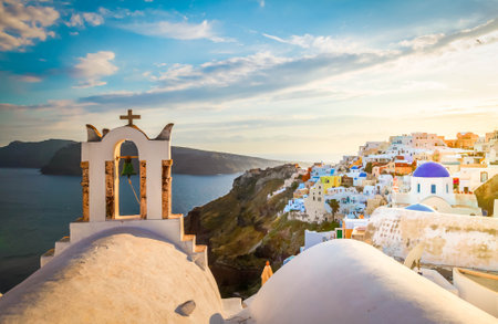 white church belfry and volcano caldera with sea landscape, beautiful details of Santorini island, Greeceの写真素材